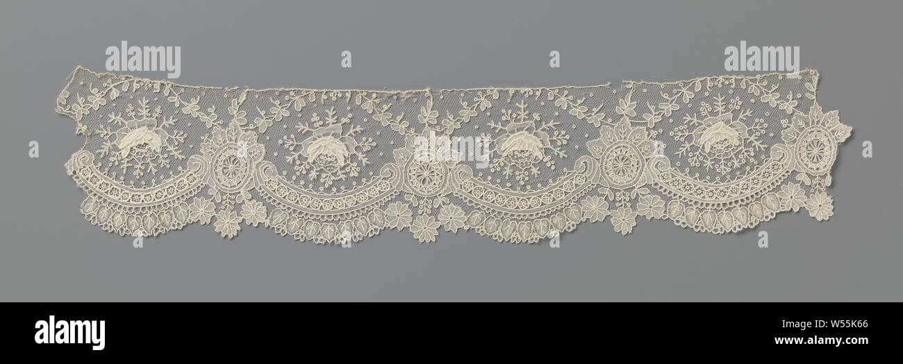 Strip of needle lace with hanging hearts, Strip of natural colored needle lace: Brussels lace. The repeating pattern consists of large semicircular shells formed by connected c-volutes. Above each volute is a single rose with a radiant wreath of short twigs with berries. The switching points between the volutes are formed by oval medallions, which are decorated with a leaf crown. From the leaf crown comes a fine sling that runs with a bow over the rose to the next medallion. The scallop edge is formed by hanging heart-shaped leaves under the volutes interspersed with three hanging daisies Stock Photo