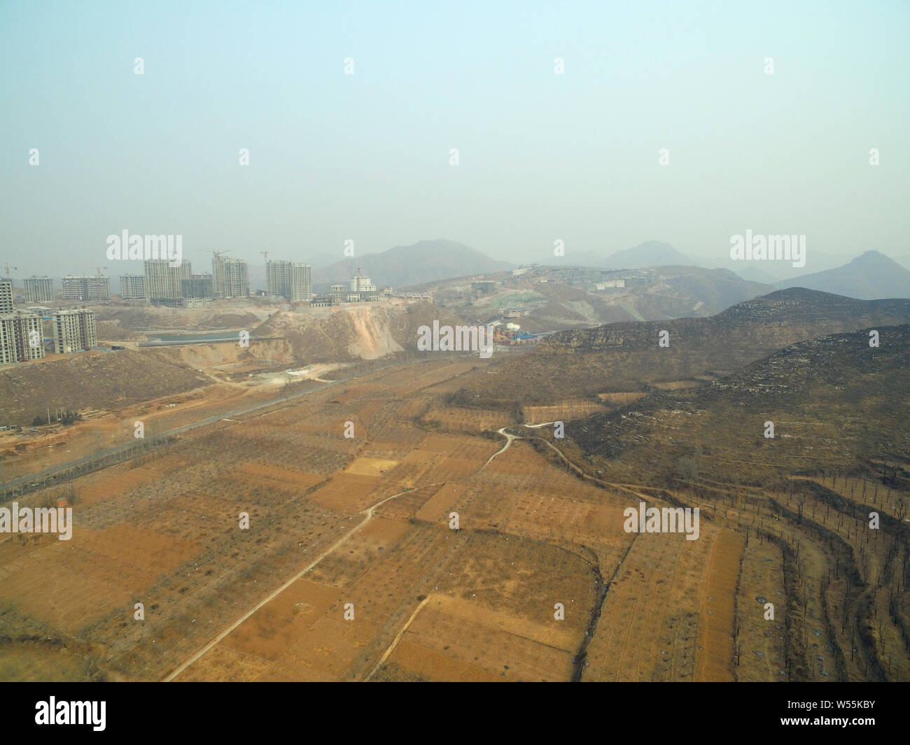 An aerial view of the mountain land and villas under construction in the Xiulan Culture Town Project developed and constructed by Xiulan Group, in Man Stock Photo