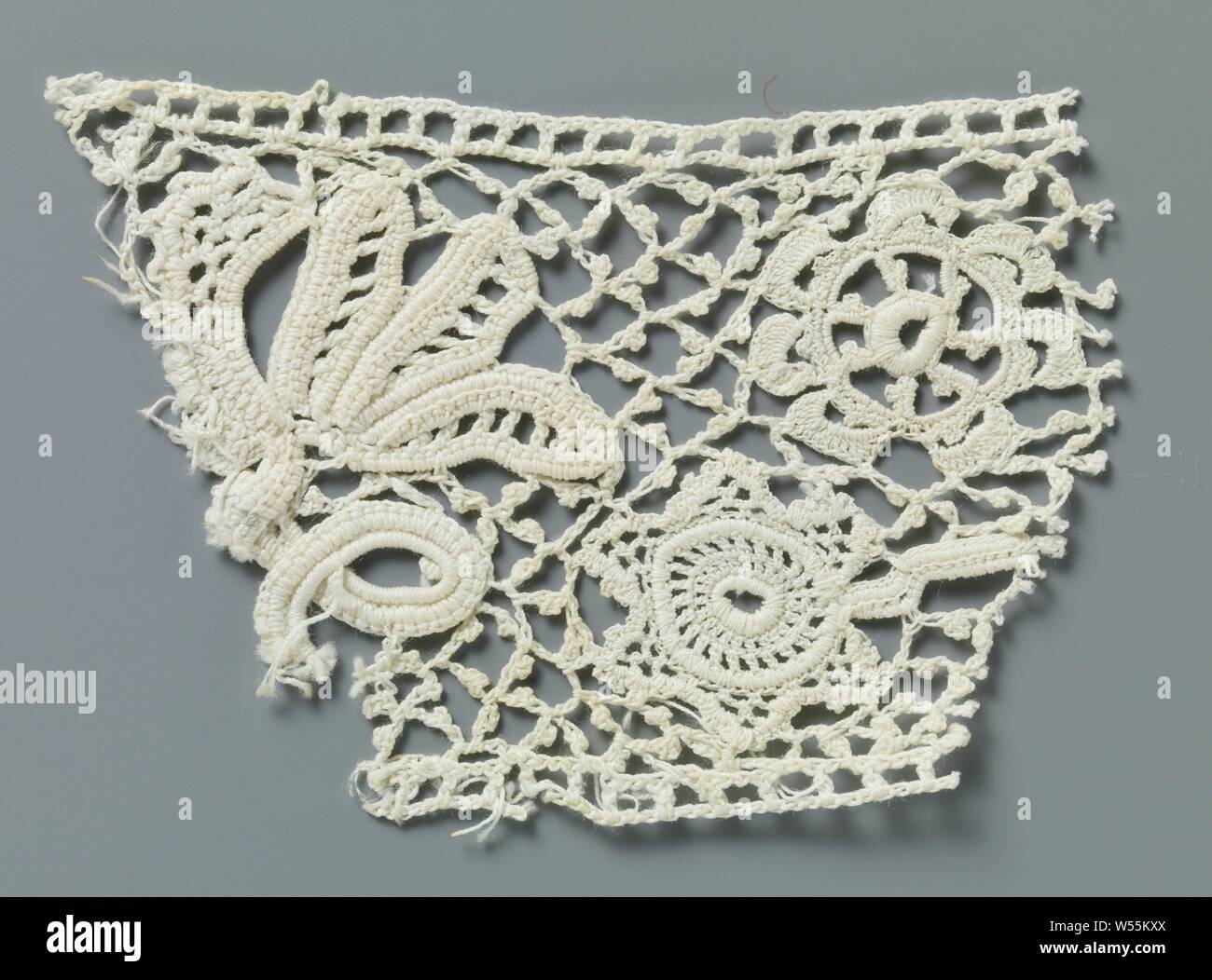 Fragment of crocheted lace with twisted twig and star-shaped flower, Fragment of natural-colored Irish crocheted lace. Pattern in which a twisted flower twig with a rosette flower and several elongated leaves is alternated by a hanging star-shaped flower on a short stalk without a leaf. Crocheted diamond mesh with picots. The top is finished with a straight edge. The undulating bottom edge is trimmed with three-part bowed arcs., anonymous, Ierland, c. 1890 - c. 1909, cotton (textile), l 8.5 cm × w 6 cm, Delft, c. 1690–1700 Stock Photo