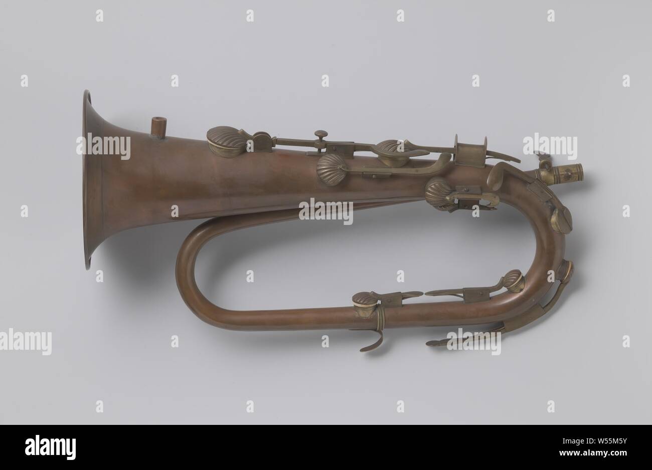Keyed bugle, Valve bracket in C with nine valves, the lower of which is open with clamping screw. The valves in the shape of convex, ribbed shells are mounted in saddles and close on sleeves around the holes. The sixth valve cover was later replaced by a flat, round cover. With support saddle for the middle finger of the right hand. The key of the third valve continues below. Also support hook for the little finger of the left hand. Nozzle missing., anonymous, Germany, 1830 - 1850, copper (metal), h 43.0 cm × w 22.5 cm d 15.7 cm Stock Photo