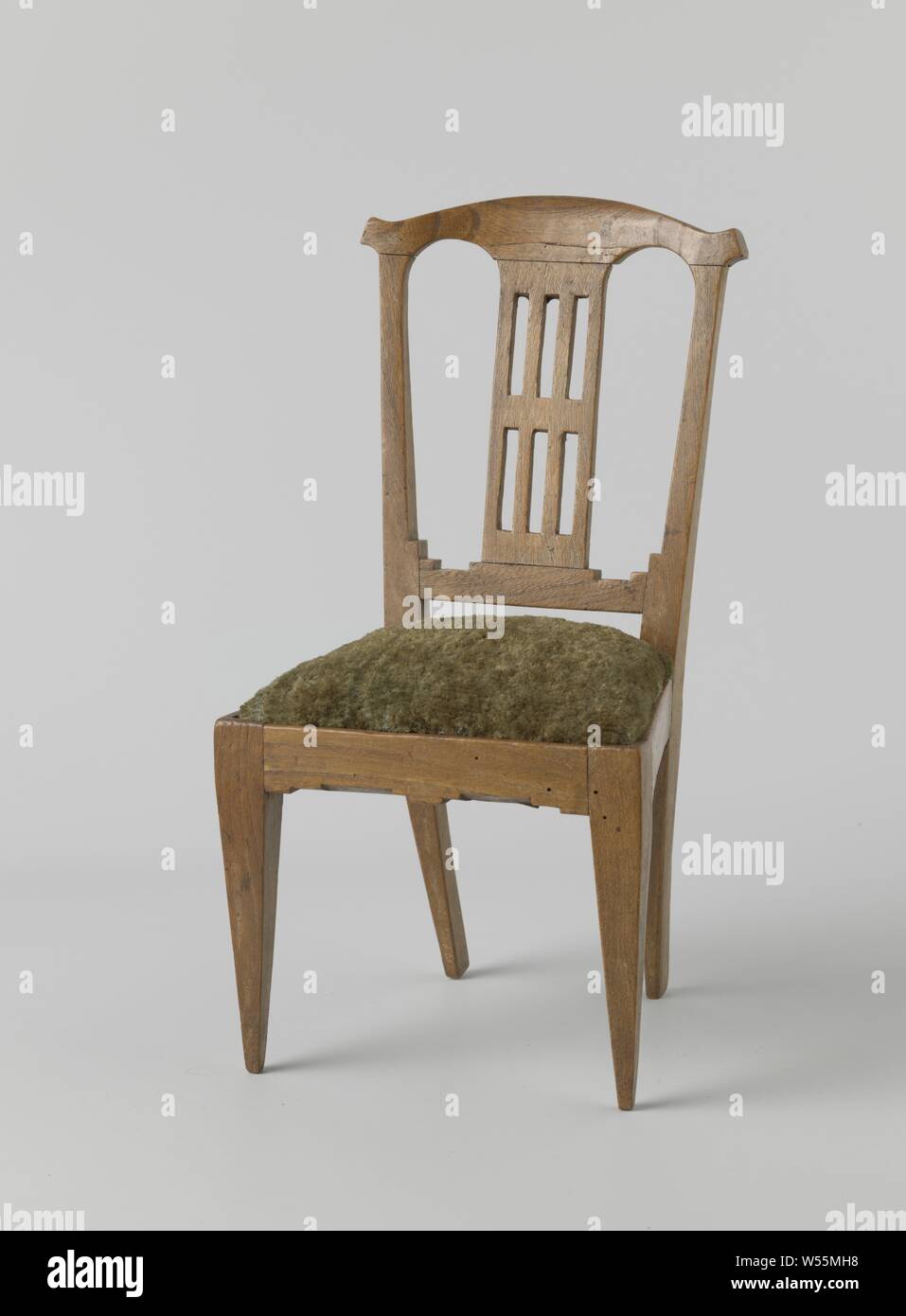 Furniture, Chair made of elm wood with square, downward, rejuvenating legs. The back is open with two arches, the central lane has rectangular breaks. The chair carries a loose cushion of green fabric., anonymous, Northern Netherlands, 1800, elm (wood), h 37 cm × w 19 cm × d 19 cm Stock Photo