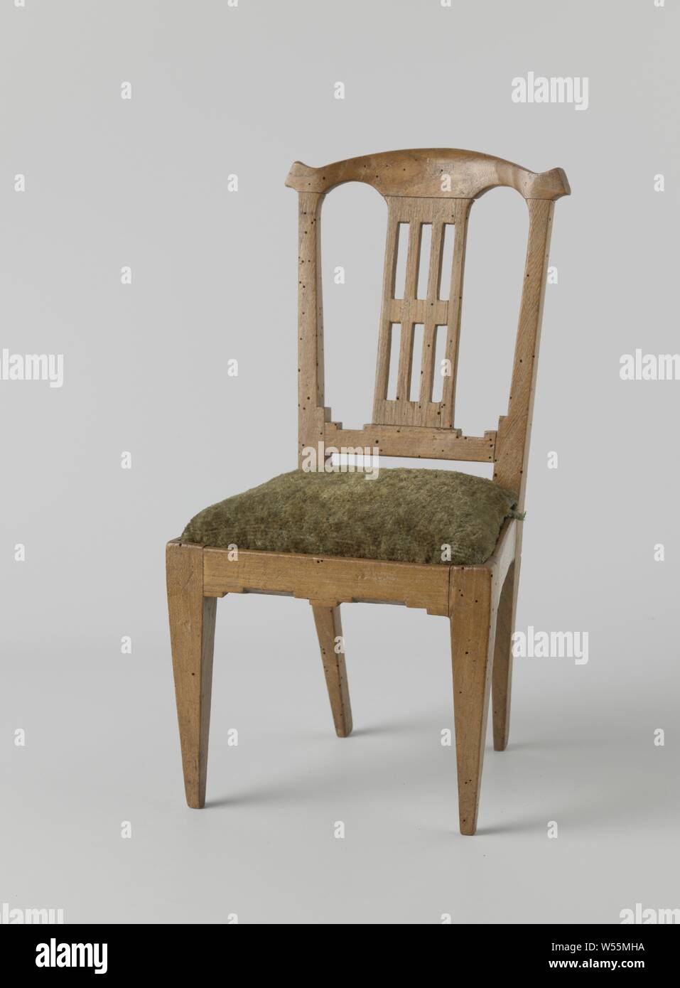 Furniture, Chair made of elm wood with square, rejuvenating legs downwards. The back is open with two arches, the central lane has rectangular breaks. The chair carries a loose cushion of green fabric., anonymous, Northern Netherlands, 1800, elm (wood), h 37 cm × w 19 cm × d 19 cm Stock Photo