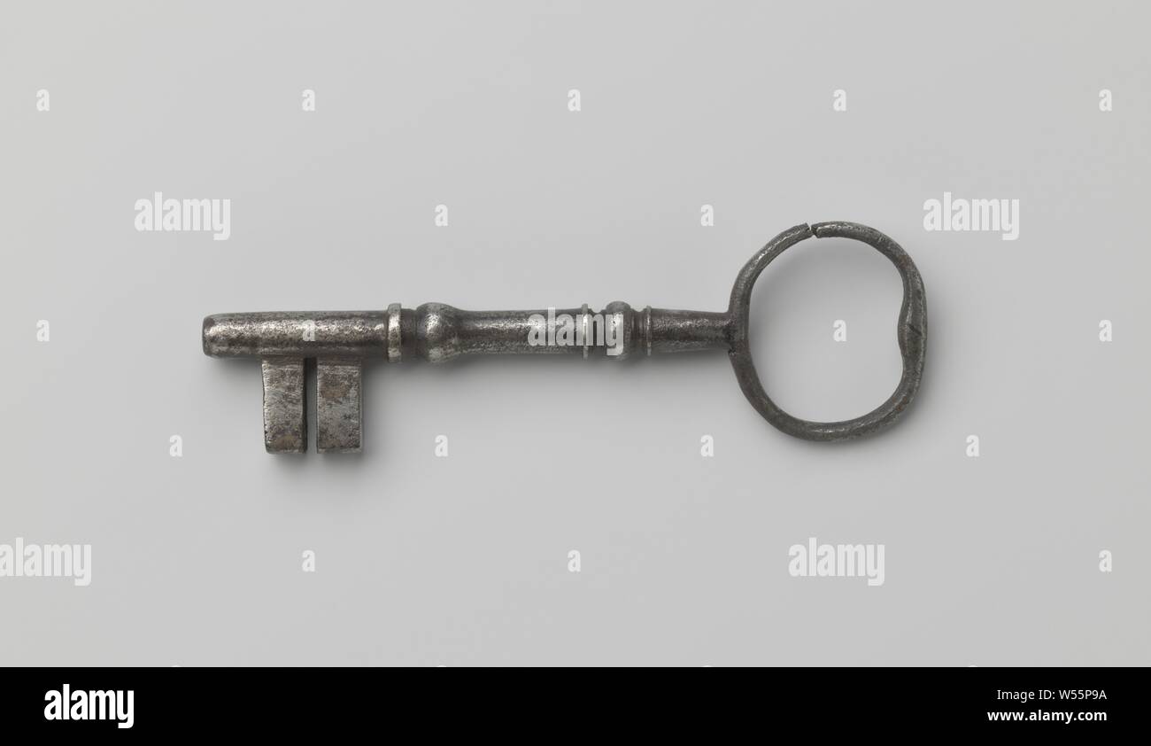 Key, key with baluster-shaped shaft that runs past the double beard. The round eye is cracked on the side., c. 1600 - c. 1699, iron (metal), l 13.4 cm × w 4.1 cm Stock Photo
