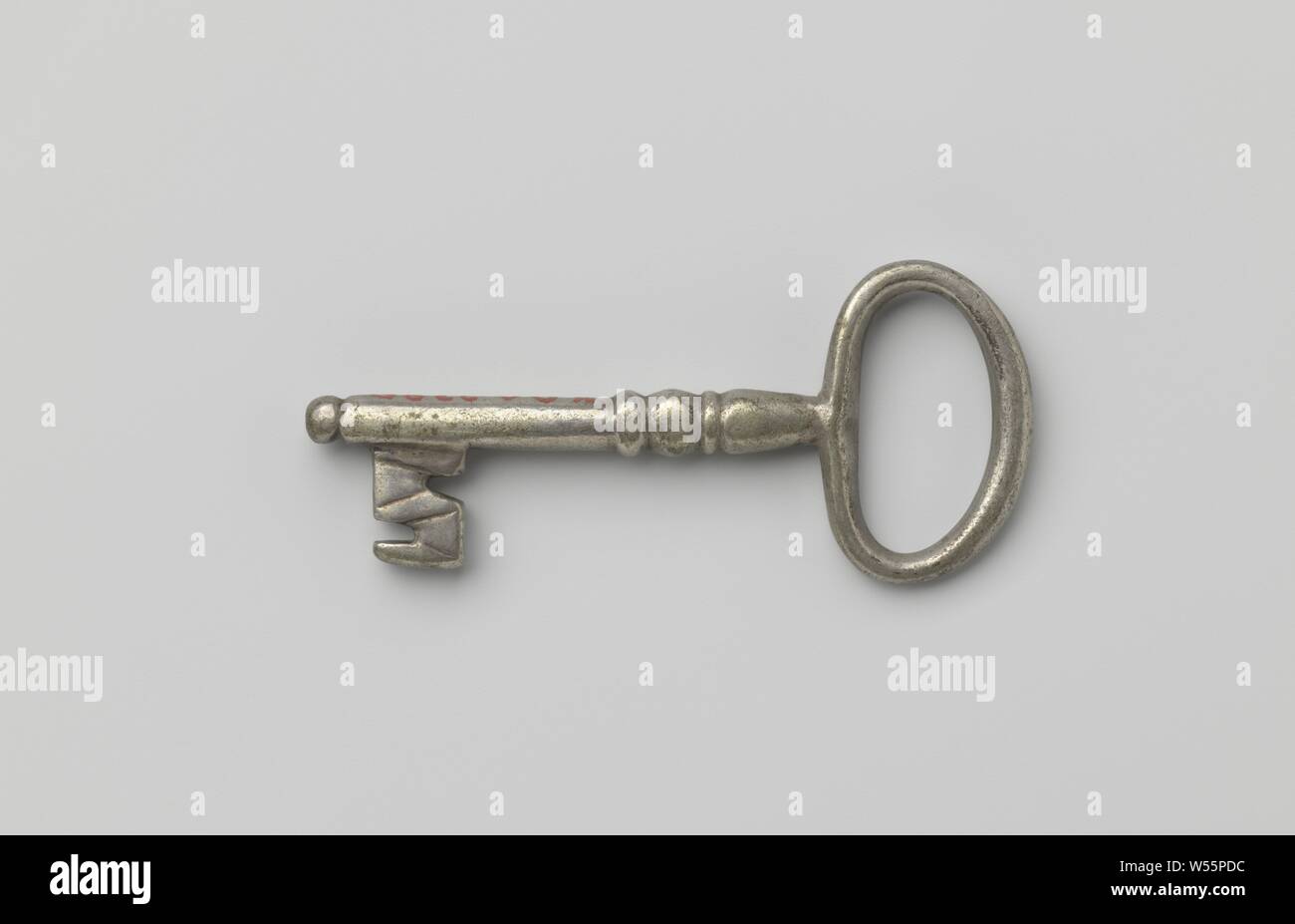 Key with oval eye, simple profiled shaft that runs past the beard and ends in a button., c. 1600 - c. 1699, silver (metal), l 5.7 cm × w 2.5 cm Stock Photo