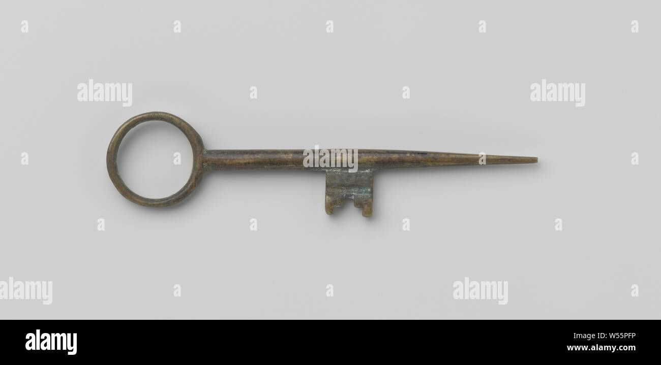 Key with ring-shaped eye. The shaft runs past the beard in a long point. Belonging to a padlock., Spain (possibly), c. 1600 - c. 1699, bronze (metal), l 10.4 cm × w 2.3 cm Stock Photo