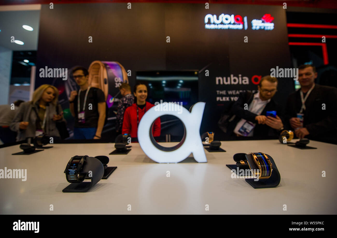Visitors view Nubia Alpha smartwatches on display during the Mobile World Congress 2019 (MWC19) in Barcelona, Spain, 25 February 2019. Stock Photo