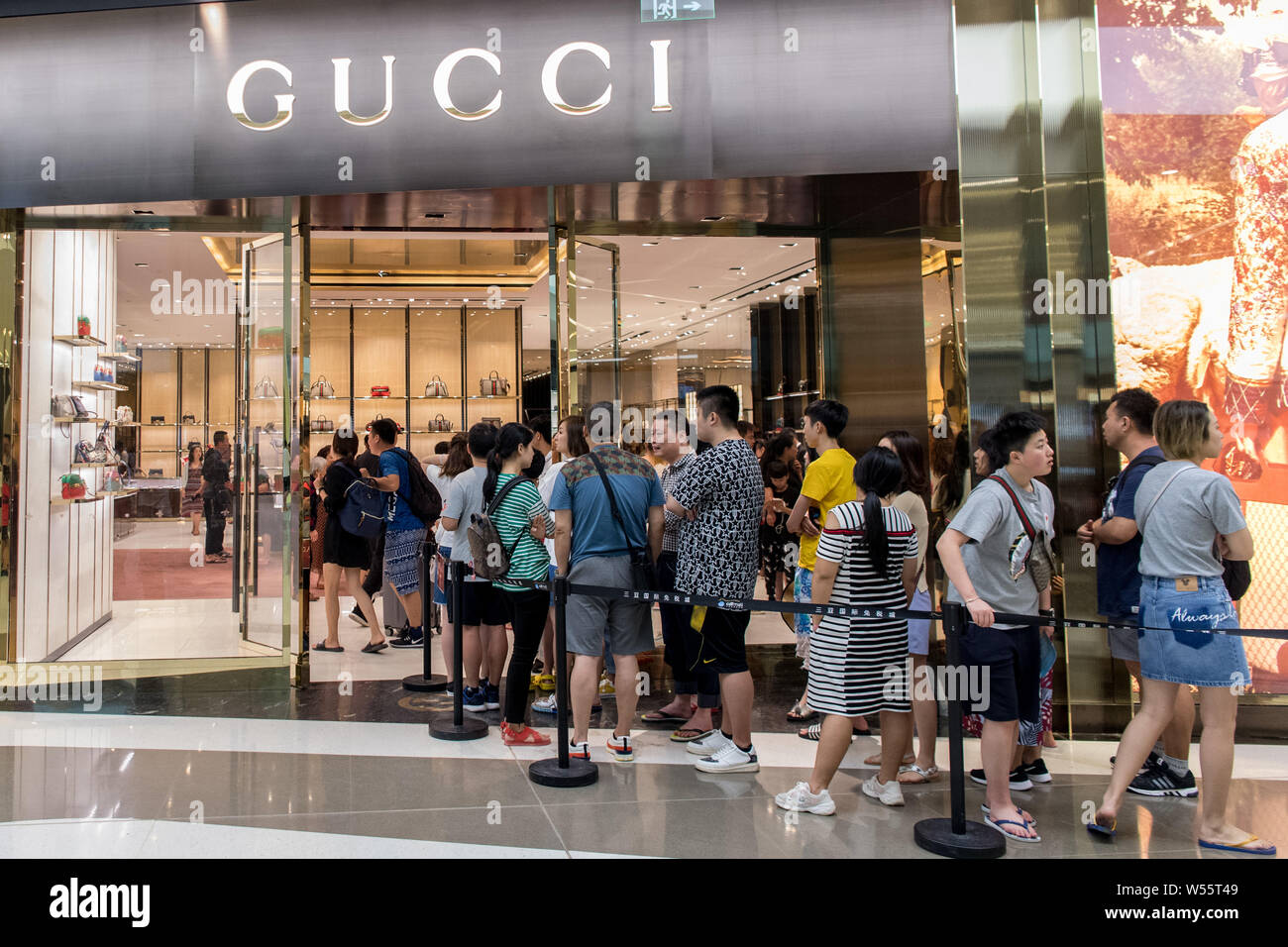 Customers queue up in front of a store of Gucci at the Sanya International  Duty Free City in Sanya city, south China's Hainan province, 14 February 20  Stock Photo - Alamy