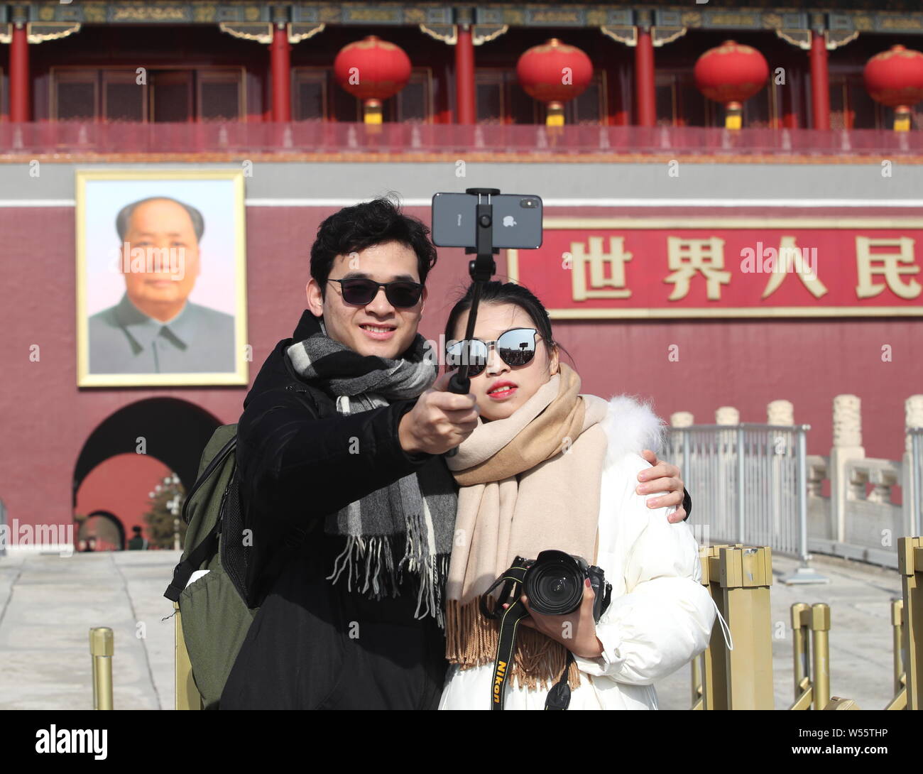 Rotrum Tourists take a selfie with a smartphone in front of the Tiananmen ...
