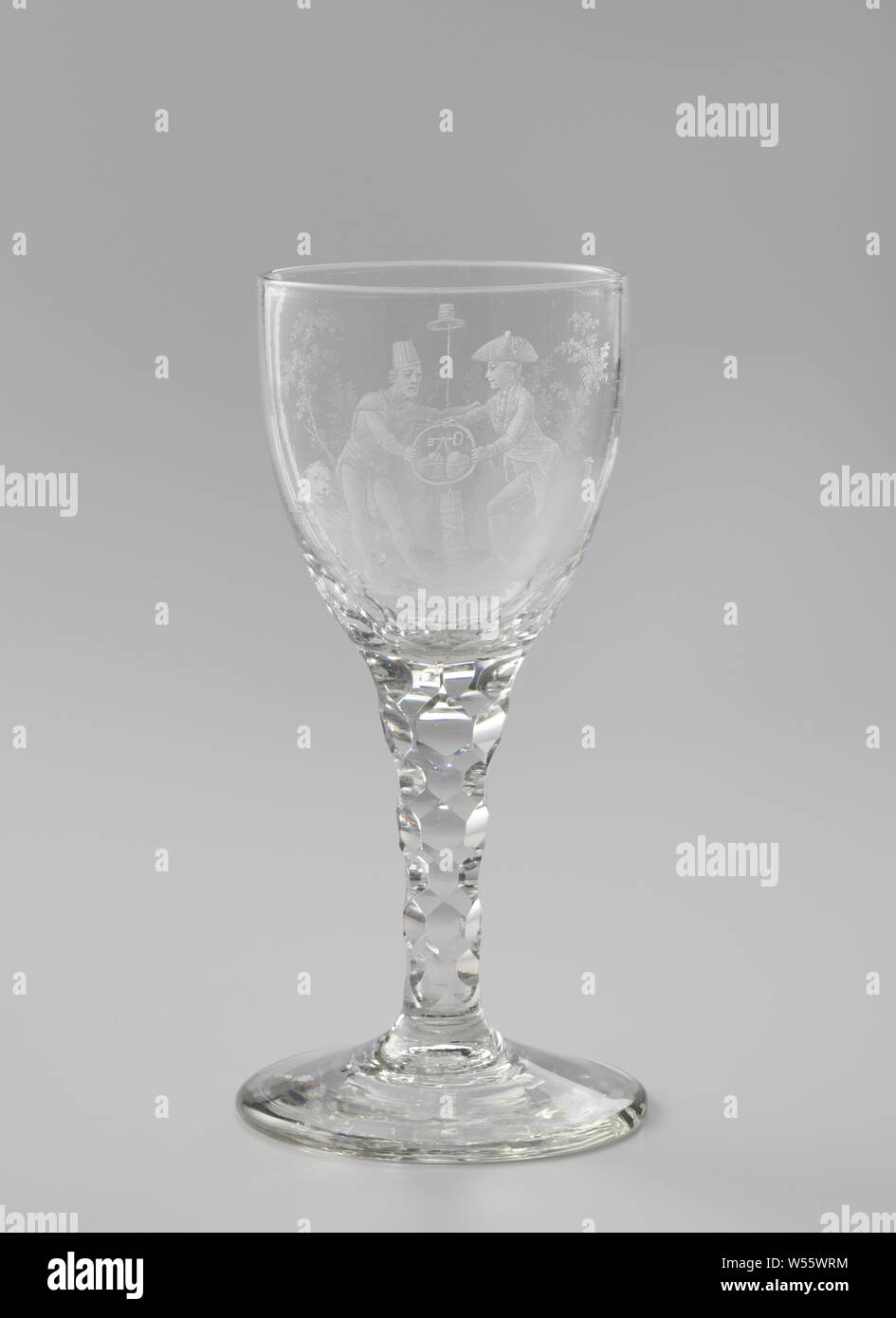 Chalice with allegorical representation, Conical foot. Widening, faceted trunk, becoming a curved chalice. On the chalice an allegory on the alliance between the Batavian and the French Republic, which was closed on 16 May 1795. In a landscape with trees stand a Batavier and a Frenchman, who hold each other's arms and hold a snake together, who own tail bites. In the circle that forms the snake, two hearts hang on a key. The Batavier kicks on a yoke and buoys, the Frenchman on a crown and a scepter. Between them in fasces and a lance with a freedom hat. On the left the Batavian lion, on Stock Photo