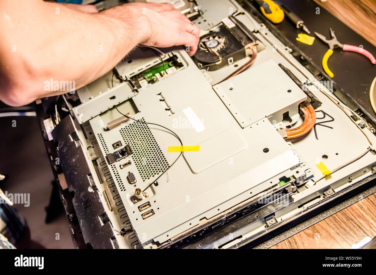 man disassembles monoblock for repair and cleaning Stock Photo