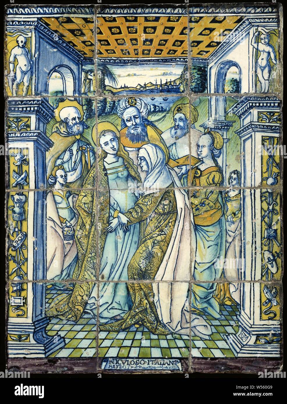 Tile panel with a representation of the Visitation, Tile panel of multi-colored majolica, consisting of twelve tiles. The meeting of Maria and Elisabeth is painted on the tiles. A group of people is standing in a portico with a cassette ceiling and square columns: on the left is Maria and on the right is Elisabeth, behind this is a girl, three men, a woman and a girl. On the middle tile of the lower edge is the text: 'NICVLOSO ITALIANO ME FECIT' painted., Visitation (possibly Joseph and / or Zacharias present) (Luke 1: 39-56), Francisco Niculoso, Sevilla, 1504, earthenware, tin glaze, lead Stock Photo