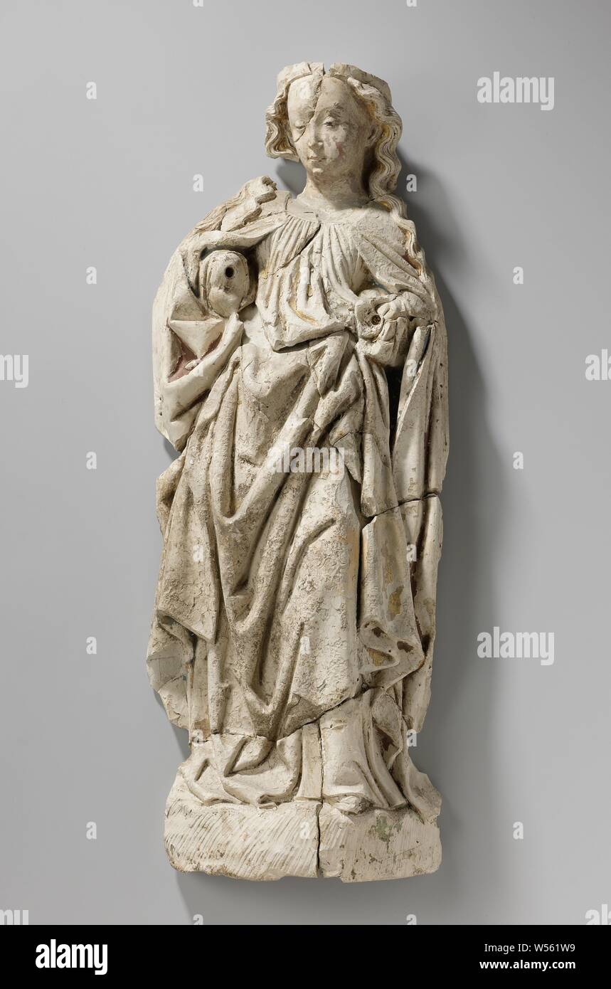 Female Saint, Probably Virgin and Child, She stands on a high ground with her left leg slightly forward, her arms bent and her head inclined slightly to the left, the wavy hair depends on the back and shoulders. Her robe, pleated at the round neckline, is included under the left arm. The cloak, closed at the neck, hangs open from the front and is incorporated under the right arm. The left shoe point protrudes under the robe., anonymous, Utrecht, c. 1470 - c. 1480, pipe clay, gilding, h 60 cm × w 24 cm × t 11 cm × w 3.4 kg Stock Photo