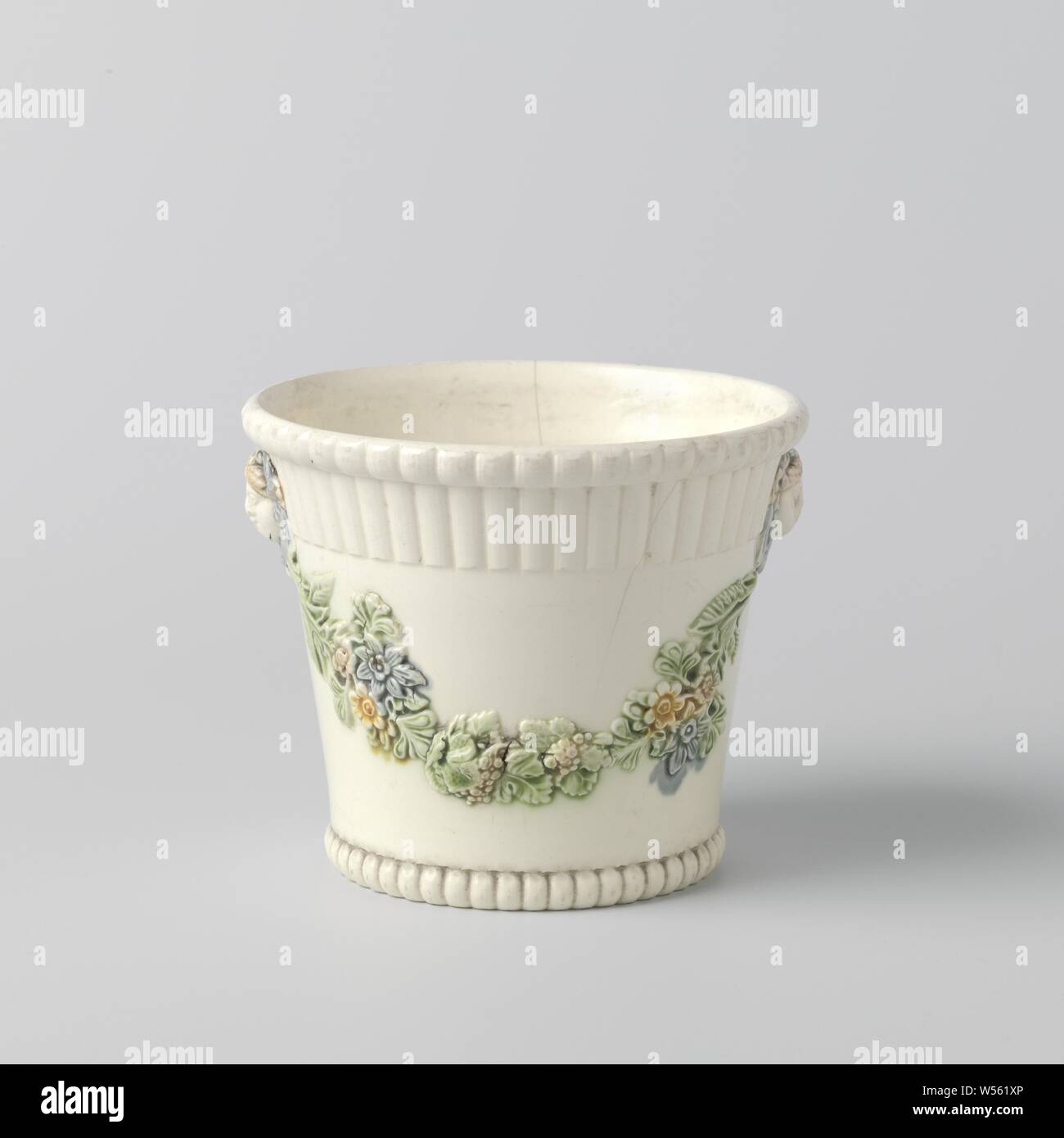 Flowerpot made from hard-fired earthenware, with a multicolored decoration, Wedgwood, Cup-shaped flowerpot made from hard-fired earthenware. The top and bottom edges are ribbed. The pot is decorated with multicolored festoons and embossed masks. The pot is unnoticed., England, c. 1780 - c. 1810, earthenware, h 10.9 cm × d 12.0 cm d 9.3 cm Stock Photo