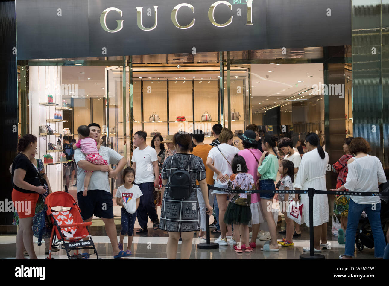 Customers queue up in front of a store of Gucci at the Sanya International Duty  Free City in Sanya city, south China's Hainan province, 14 February 20  Stock Photo - Alamy
