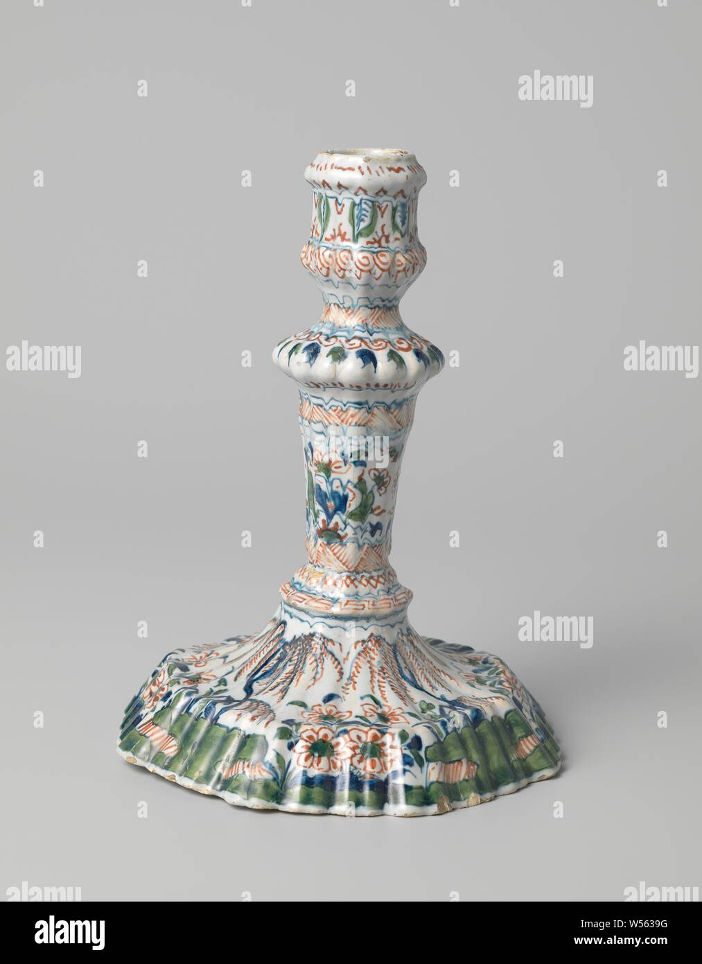 Candlestick with multicolored painting, Candlestick of faience, multicolored painted under the glaze. Octagonal foot, fluted trunk. Unnoticed., anonymous, Delft, c. 1690, h 19 cm × d 14 cm Stock Photo