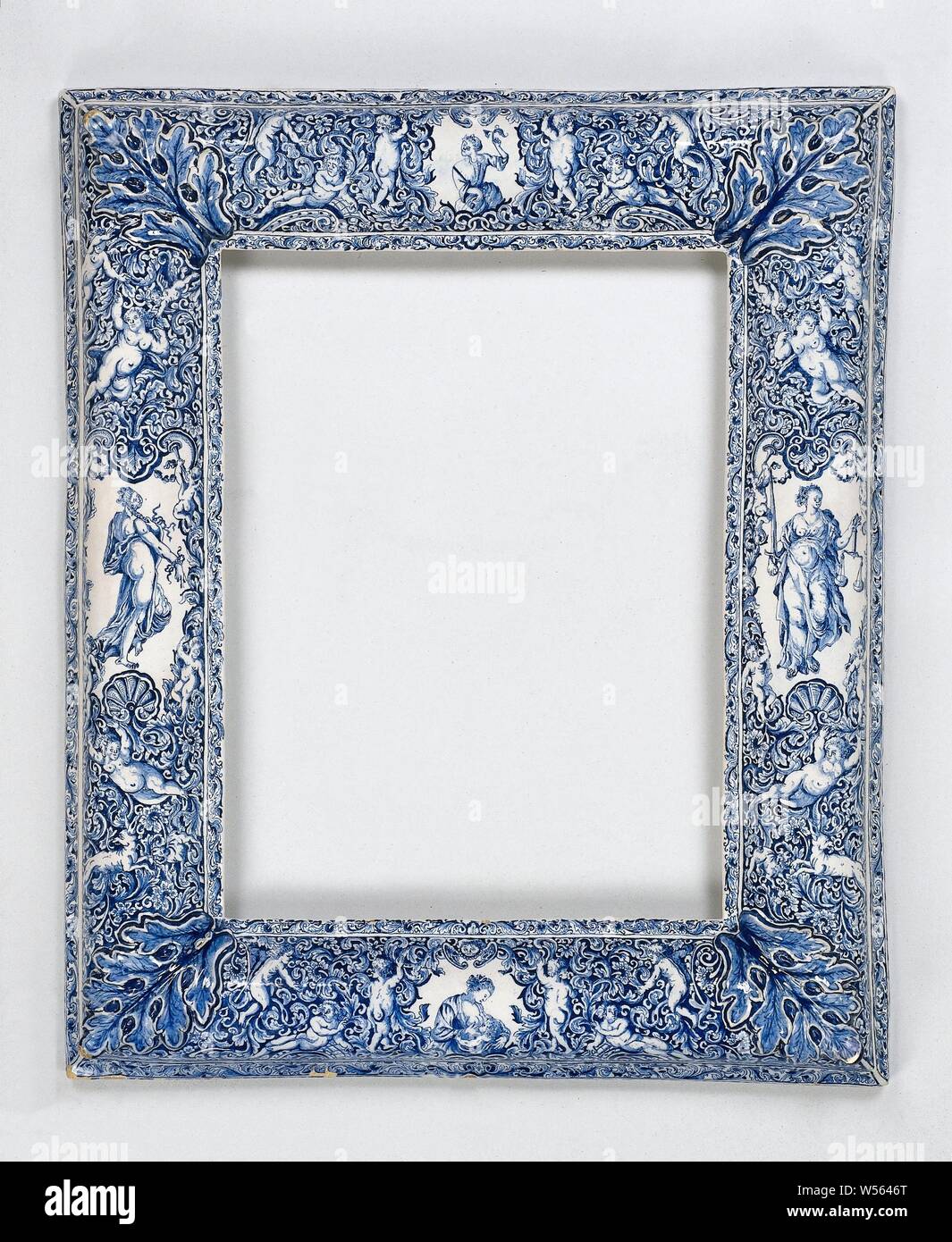 Mirror frame, painted with four allegorical female figures, Mirror frame of faience, painted in blue with four allegorical female figures, Prudence, 'Prudentia', 'Prudenza' (Ripa), one of the Four Cardinal Virtues, Justice, 'Justitia', 'Giustitia divina' (Ripa), Charity, 'Caritas', 'Carità' (Ripa), one of the Three Theological Virtues, Temperance, 'Temperantia', 'Temperanza' (Ripa), De Witte Starre (attributed to), Delft, 1736, h 65 cm × w 54 cm Stock Photo