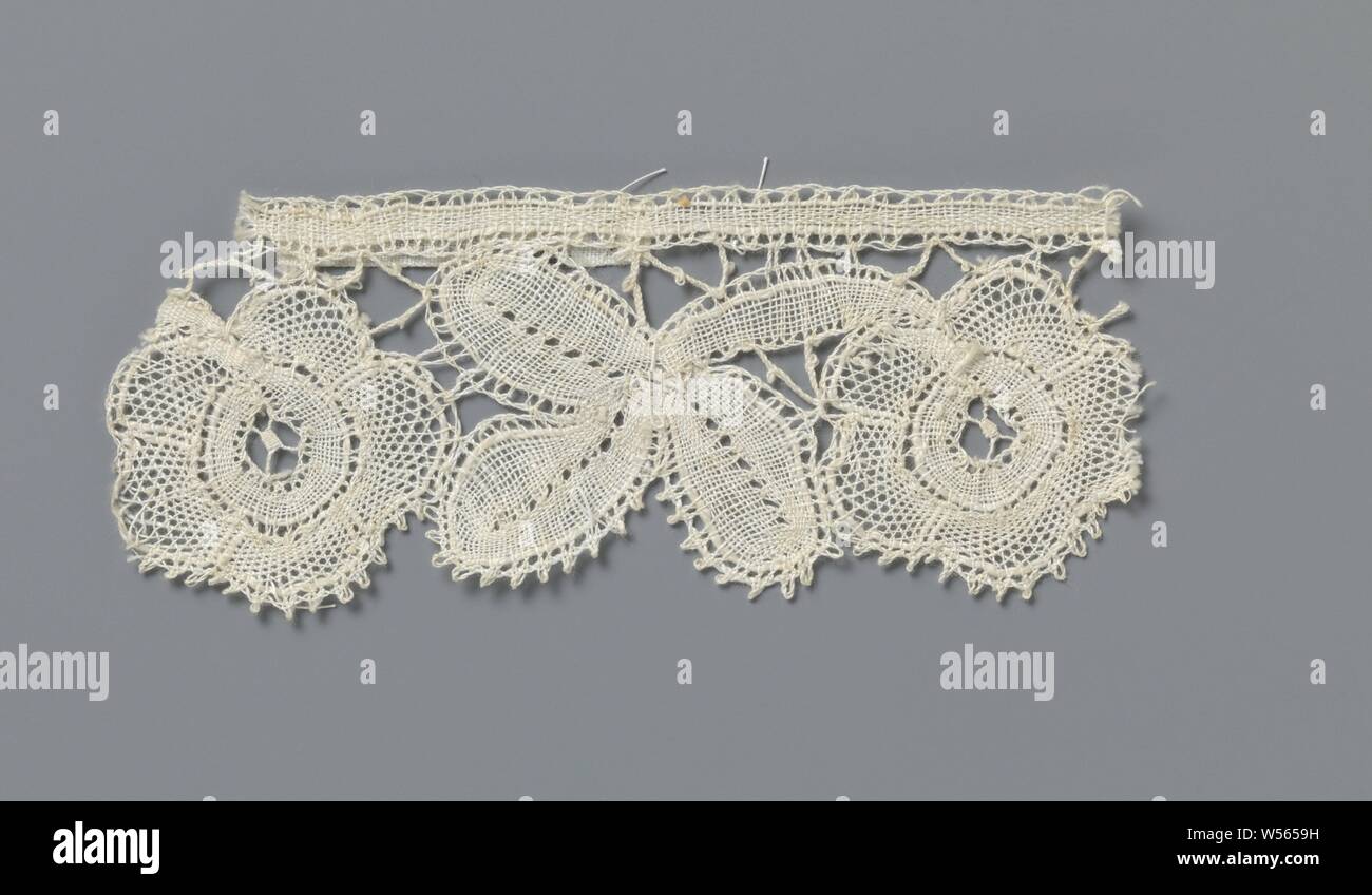 Strip of bobbin lace with three-lobed leaves between two rosette flowers, Strip of natural-colored bobbin lace: fine Bruges floral arrangement. The pattern consists of a three-lobed leaf between two rosette flowers. The motifs are attached to a straight band at the top and connected to each other by a few painted braids. The straight band and the tri-lobed leaf are made in linen, with contour threads within the openwork edges and with cut-outs like leaf veins. The petals of the rosette flowers are made in net strokes with contour threads and the flower hearts are made in linen strokes, Stock Photo
