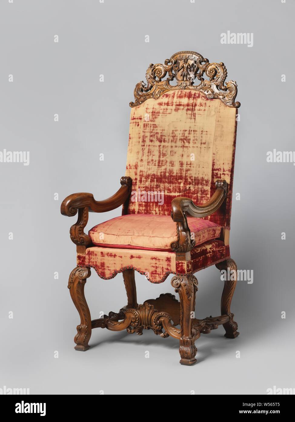 https://c8.alamy.com/comp/W565T5/judges-chair-made-of-walnut-and-elm-wood-covered-with-red-velvet-and-with-a-loose-cushion-with-inserted-attachment-with-acanthus-volutes-and-shield-with-lambrequins-depicting-justitia-judges-chair-with-walnut-legs-and-armrest-struts-made-of-elm-wood-covered-with-red-velvet-and-with-a-loose-cushion-it-rests-on-s-shaped-legs-placed-at-an-angle-decorated-with-acanthus-leaves-the-armrests-are-hollowed-and-end-in-a-volute-the-upper-threshold-has-a-stabbed-attachment-adorned-with-acanthusvoluten-on-either-side-of-a-shield-with-lamb-brekin-on-which-justitia-stands-probably-W565T5.jpg
