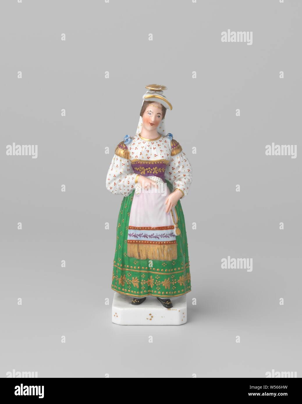Bottle in the shape of a woman in folk costume, Bottle of porcelain, painted on the enamel in enamel colors and gold. The bottle is in the shape of a woman in French costume. On her head the opening, closed with a porcelain stopper. Marked on the bottom with J.P., school van Fontainebleau, Fontainebleau, c. 1800 - c. 1810, porcelain (material), glaze, gold (metal), vitrification, h 18.2 cm w 6.6 cm × d 5.5 cm Stock Photo