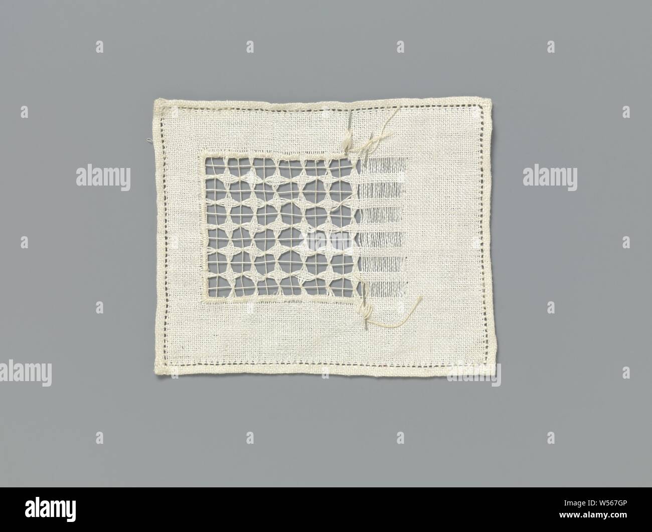 Steel linen with lace embroidery with pulled-out threads and four-pointed stars in a square grid, Steel natural-colored linen with lace embroidery: work with pulled-out threads. Study material. In a considerable part of the linen a square grid has been created by pulling out threads in the horizontal and vertical directions. With an added thread a start has been made with bundling the remaining threads that form the grid and finishing the edges around the grid with festival stitches. The bundling is carried out in horizontal and vertical lines, the added thread thus forms its own square grid Stock Photo