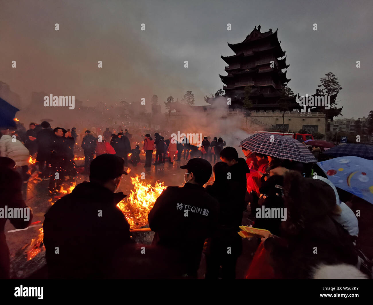Chinese worshippers burn incense sticks to pray for wealth and ...
