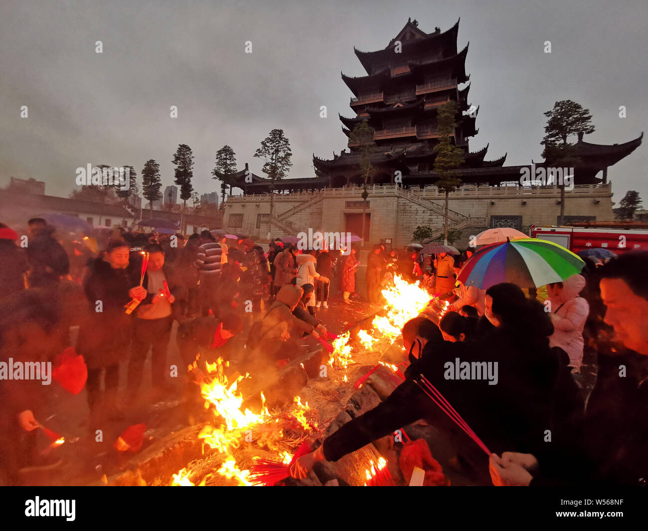 Chinese worshippers burn incense sticks to pray for wealth and