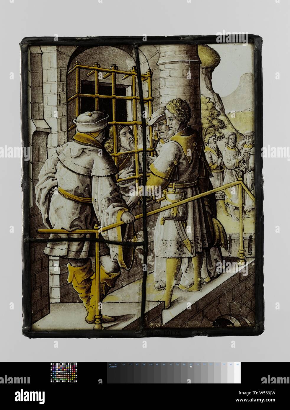 Windowpane with a visit to John the Baptist in prison, Windowpane with figures, one behind bars. Three people are talking to a prisoner. Three more people are on the horizon., anonymous, Northern Netherlands, c. 1500 - c. 1550, glass, silver stain, h 23 cm × w 18.5 cm Stock Photo