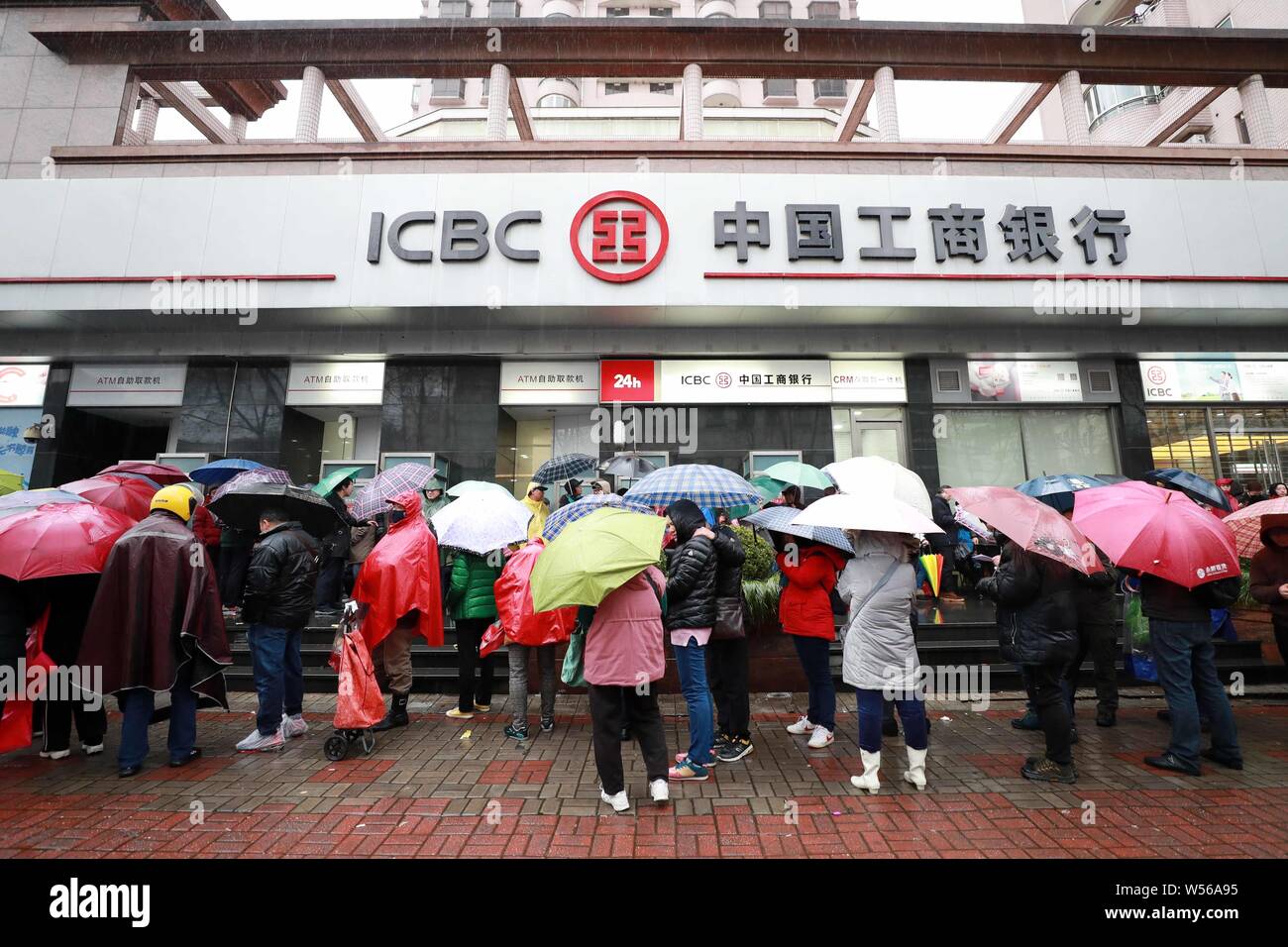 Local Chinese residents queue up outside a branch of Industrial and ...