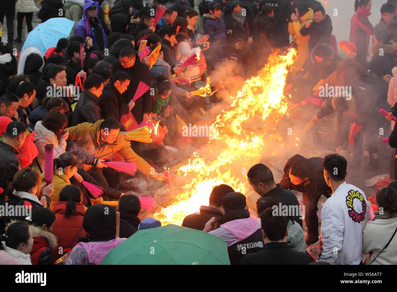 Chinese worshippers burn joss sticks (incenses) to pray for good fortune and blessing during the Chinese Lunar New Year or Spring Festival at the Guiy Stock Photo