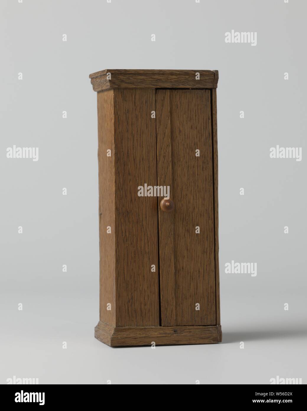 Wardrobe with one door, with profiled skirting board and hood, High smooth  oak cabinet, front half closed, half with a door with a round palm-wood  knob. Inside five clothes hooks and an