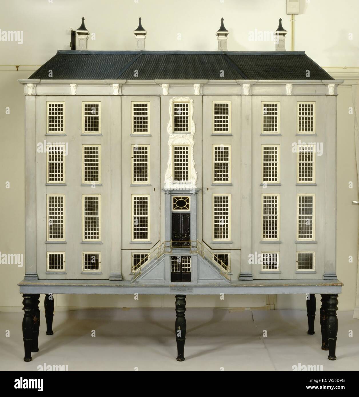 Canal House, Dollhouse in the shape of a house with middle riser, pavement and roof with chimneys. The facade can be removed. The house is divided into a basement area with two cellars, portal and kitchen, first floor with hall, front hall, staircase, dining room, second floor with bedroom, front room, stairs and children's room, attic floor with two attics., anonymous, Netherlands, 1760, wood (plant material), pine (wood), oak (wood), paint (coating), glass, h 213 cm × w 245 cm × d 70 cm Stock Photo