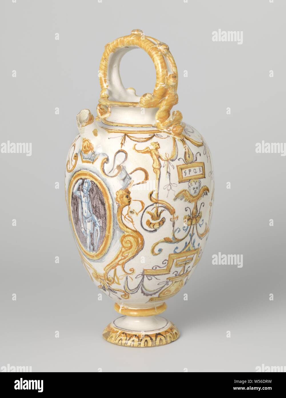 Vase, decorated with warriors in cartouche and SPQR inscription, Vase of multi-colored majolica. The inverted egg-shaped vase stands on a profiled foot. A standing ear is attached to the short neck. A cartouche is painted under the spout, inside of which a warrior with shield and spear. A cartouche has been painted on the other side, within which a warrior with sword and raised right arm. The letters SPQR are painted within two cartouches., anonymous, Urbino, c. 1580 - c. 1640, earthenware, tin glaze, lead glaze, h 29.0 cm × d 13.0 cm Stock Photo