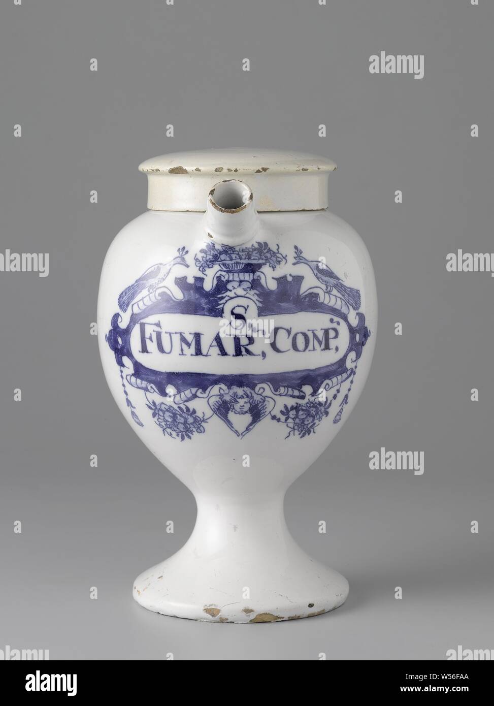 Pharmacy jar with inscription S, / FUMAR, COMP, Pharmacy jar of faience. With ear and spout and blue painted label with inscription: S, COMP, ., anonymous (mentioned on object), Delft, c. 1750 - c. 1800, h 22 cm × w 19 cm d 14.5 cm Stock Photo