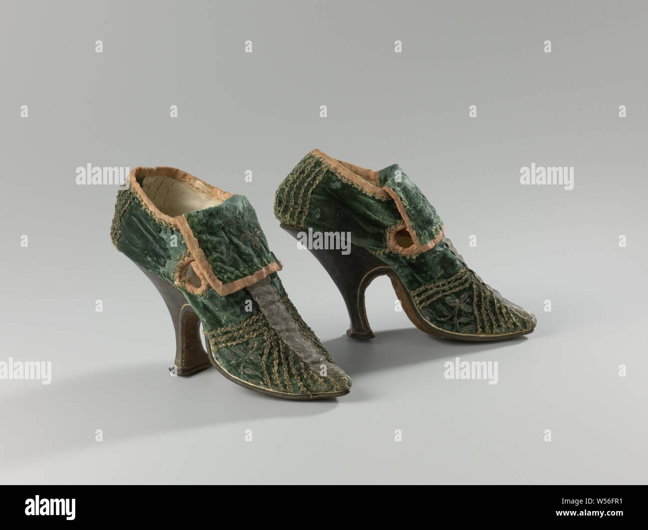 Pair of High-Heeled Women's Shoes Pair of women's high-heeled shoes Green  velvet women's shoe decorated with vertical and diagonal silver trims, with  thin high leather heel, Green velvet women's shoe decorated with