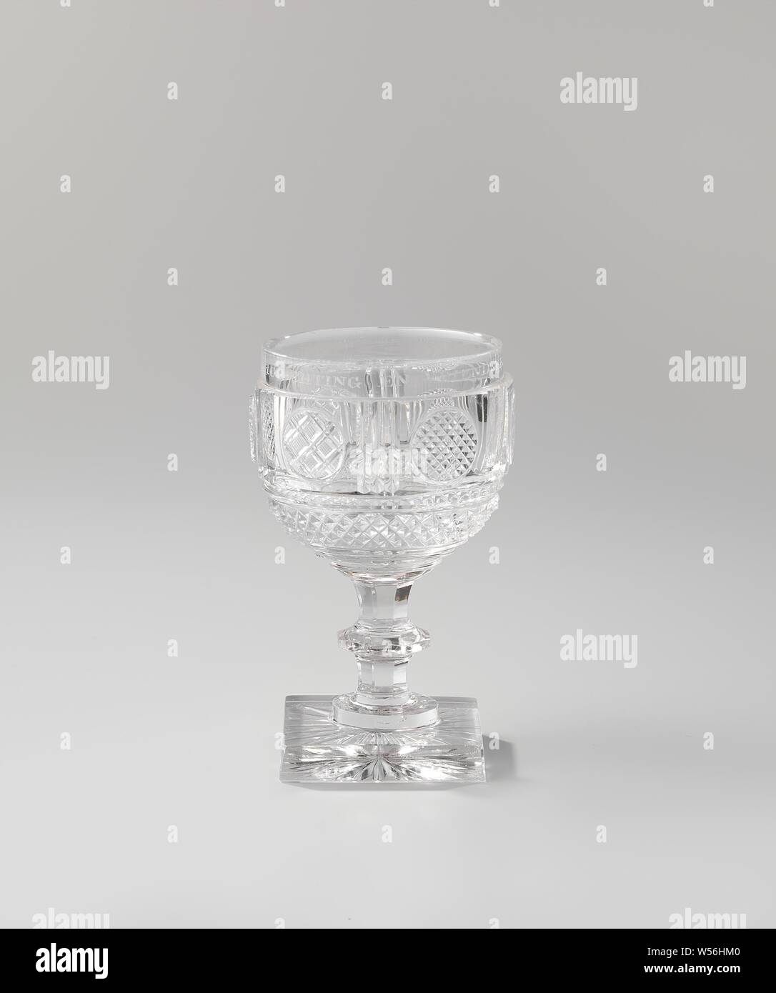 Chalice on a square base, with the inscription: CITADEL ANTW. 1830 & 1831 H J v Mourik 2 Lt Kwartm, Thick, square, smooth base, star-shaped underside. Faceted stem with a disk. Spherical cup with a smooth mouth edge. The chalice has three rings at the bottom, above which a diamond-shaped band in relief, after which six medallions, interrupted by vertical notches, circles in the squares, alternately followed with diamond reliefs, top edge smooth with text: OUT OF HIGHLIGHTS AND FRIENDSHIP. Chalice m. CITADEL ANTW. 1830 & 1831 H J v Mourik 2 Lt Kwartm, Citadel of Antwerp (19th century Stock Photo