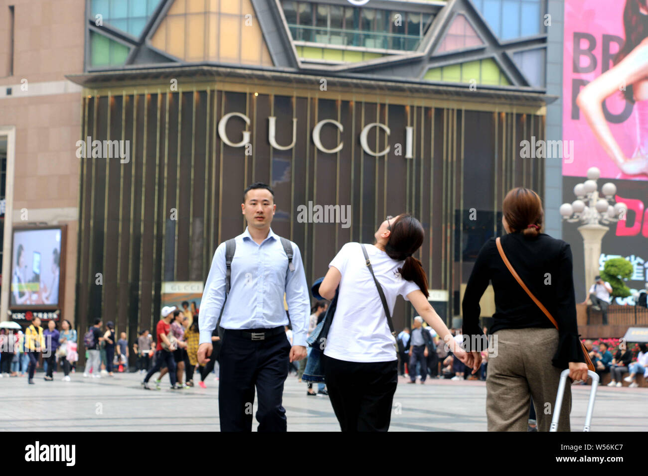 FILEPedestrians walk past a fashion boutique of Gucci in Chongqing