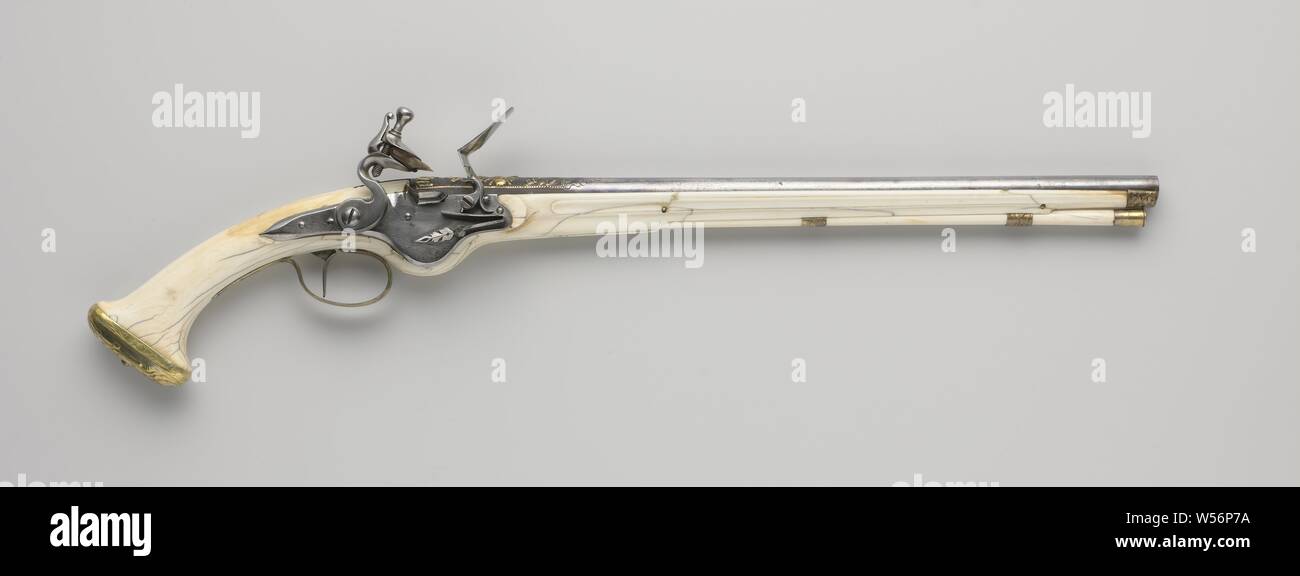 Flint gun with ivory drawer, Originally a wheellock gun, but transformed into flint, part of a couple. The lock plate in the shape of a wheel lock covers the recess where the wheel lock has been, the spring of the fire steel of the lock ends in a chiseled blade. The blued barrel is embossed on the back with flower and leaf ornaments, partly silver encrusted against a blued background, marked at the bottom with a circle and two rosettes. The solid ivory drawer is easily cut. The gilt brass fittings consist of, among other things, a drawer cap, a loop-shaped trigger guard and a round cap Stock Photo