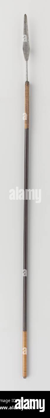 Lance of the arms rack by Indian greats donated to Governor General J.C. Baron Baud, hollow black painted wooden shaft, on which a narrow blade ends in a sharp point. The blade is attached to the shaft with finely braided reeds. The base of the blade has small pointed protrusions. At the bottom of the shaft is a handle of varnished cane, Jean Chrétien baron Baud, Java, c. 1800 - c. 1900, wood (plant material), iron (metal), paint (coating), painting, l 204 cm l 65.5 cm Stock Photo