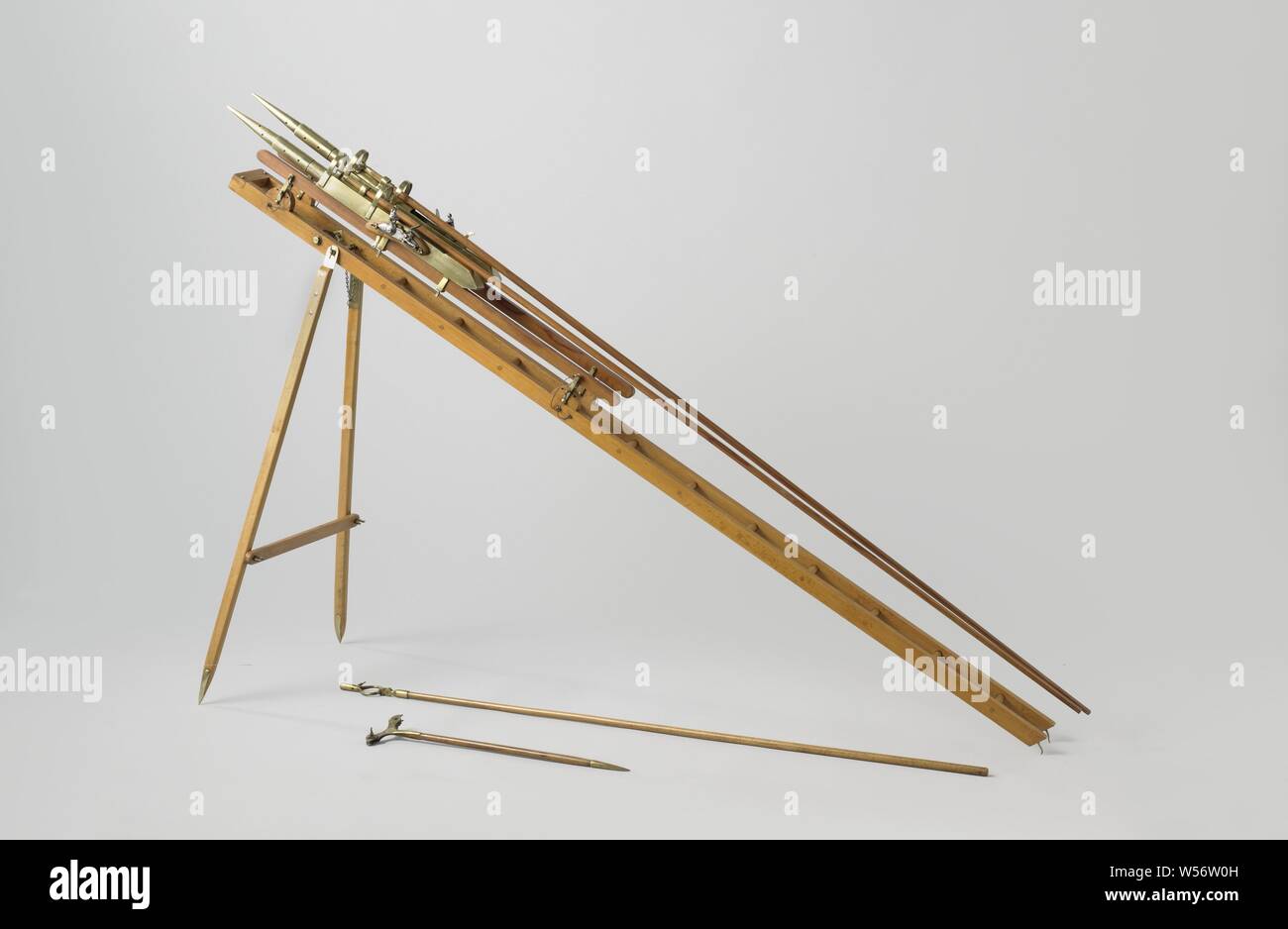 Model of Two Congreve Rockets with Launching Gear, Model of two fire missiles, designed by Congreve on a launcher or chair, for use on land. The rockets themselves consist of a pointed cylinder, the tip of which is the fire bomb and the rear part is the rocket engine, a long stabilizing pole is mounted on the outside of the cylinder. The chair consists of a ladder-shaped frame that together with two legs forms a tripod, A running ring is provided at the front of the frame, which can be wrapped around the front mast of a sloop and guides the movement of the frame during lifting and lowering for Stock Photo