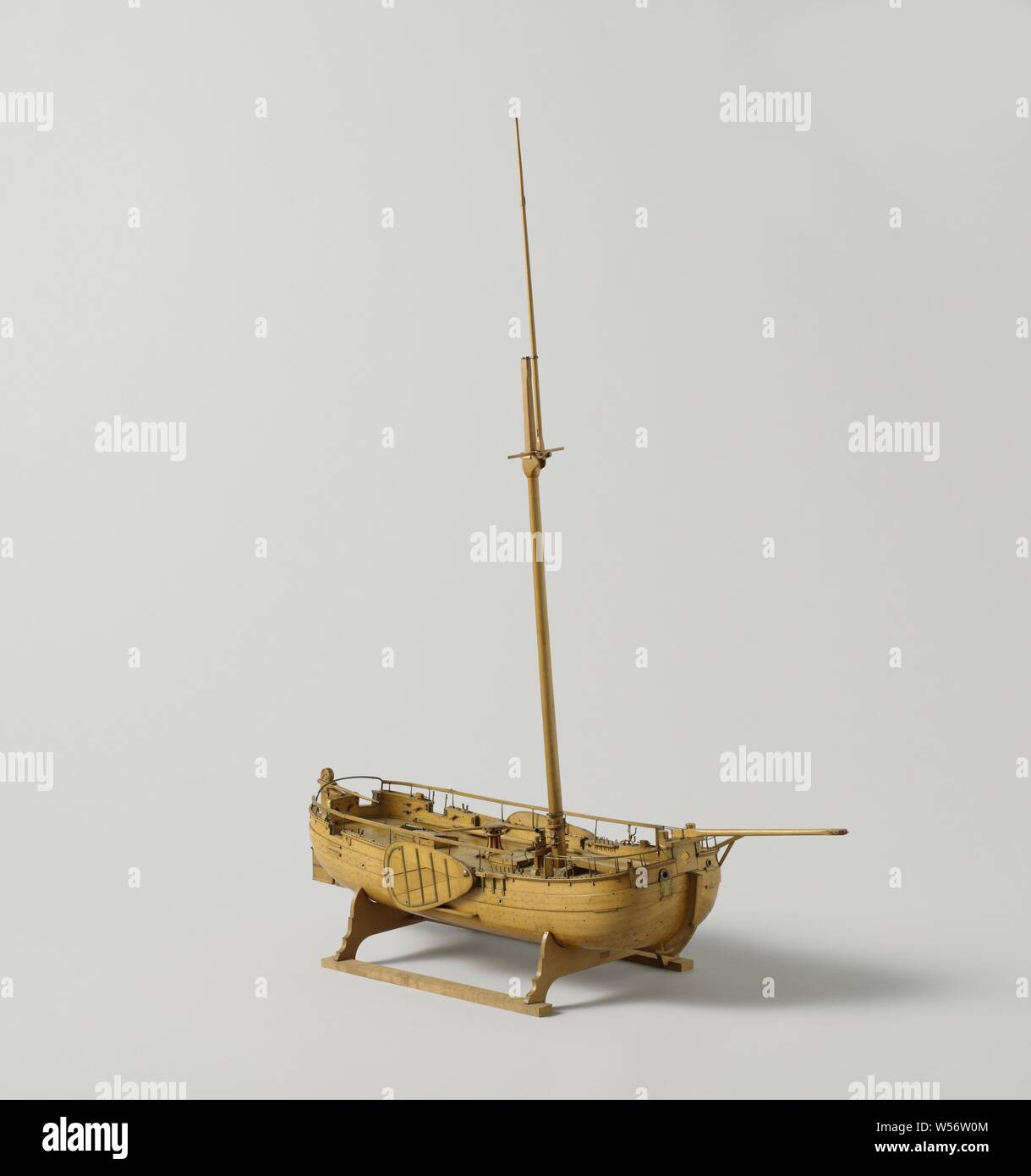 Model of a Gaff-Rigged Gunboat, Truss model with spars of a single-mast flat-bottomed gunboat, cover parts can be removed to show the firing inside. Round bow and stern, a port in the bow, two in the stern and two in the rear, a cannon on a turn slide in the bow, two carronades behind, four turning axes. The deck is detailed with a capstan, a chimney for the galley, shutters, a roef, a compass house, loading equipment for the guns, a mop and bucket, four oars, cannon balls and two anchors. A gown in the sides and four poles on either side for a higher gown. Full deck below deck and brass Stock Photo