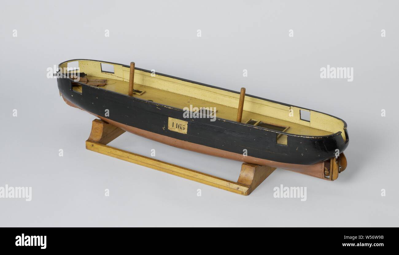 Models of a Twin Screw Steamer, Polychromed block model of a wooden twin-screw steamship, damaged. The typical feature of this model is the round stern with two sterns for the two-blade screws and the two rudders, for this two extra keels run from about halfway to the sterns. One deck with indication of shutters. Seven gun gates and a schematic model of a gun on a sliding gate, with traces for its positions on the deck. Only parts of the two masts and the bowsprit are mounted on the model. The prow is falling back, responding to the fashion of the early ram ships. Scale 1:40 (derived), ship Stock Photo