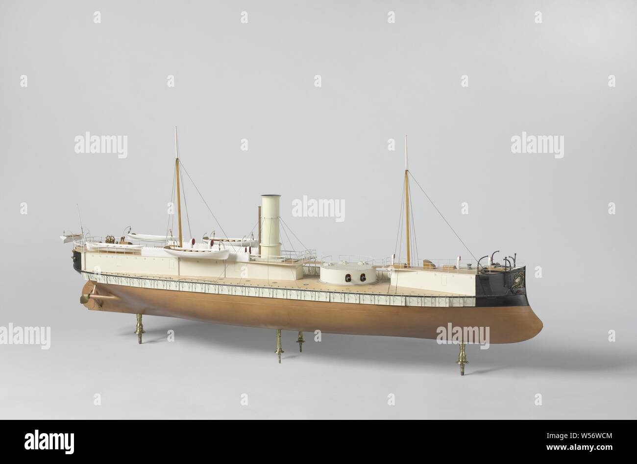 Model of an Ironclad Ram Ship, Polychromed and witnessed block model of a ram tower ship, the floorboard is missing. It has the Rijkswapen in bow and mirror. The model has a ram's stern, crutch fence with balance rudder, steering wheel on the rear of the campaign deck with two compass housings, two two-leaf screws. On the main deck there are two triangular deck superstructures, one at the rear and one at the front, which allow a maximum field of fire for the two pieces in the revolving dome, the railing can be lowered for shooting. The chimney stands on the rear deck house just behind the dome Stock Photo