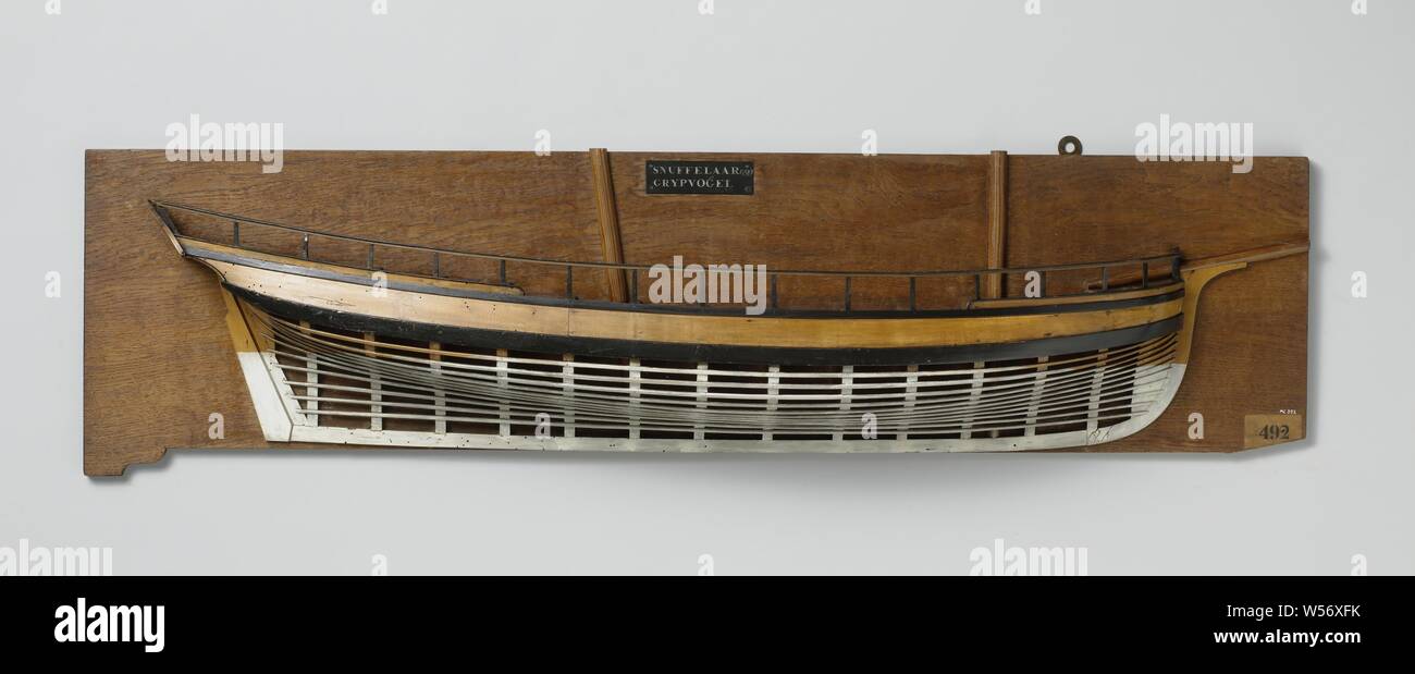 Half Model or a 4-Gun Schooner, Polychromed mold model (starboard) of a two-mast. The skin above the barwood is closed, the ship has a railing. Low around the fore ship, the prow rising to the vertical. Twisted mirror, hollow wulf, closed gate, no side gallery, sterns falling strongly, straight rudder with square rudder king, keel with heel. Sheer ascending to both ends, very high stern, one barwood and one deer. Peaked trusses, curved smock with emerging ends. The large mast leans backwards, the breeding mast is almost vertical, Rotterdam, Grijpvogel (ship), Snuffelaar (ship), anonymous Stock Photo