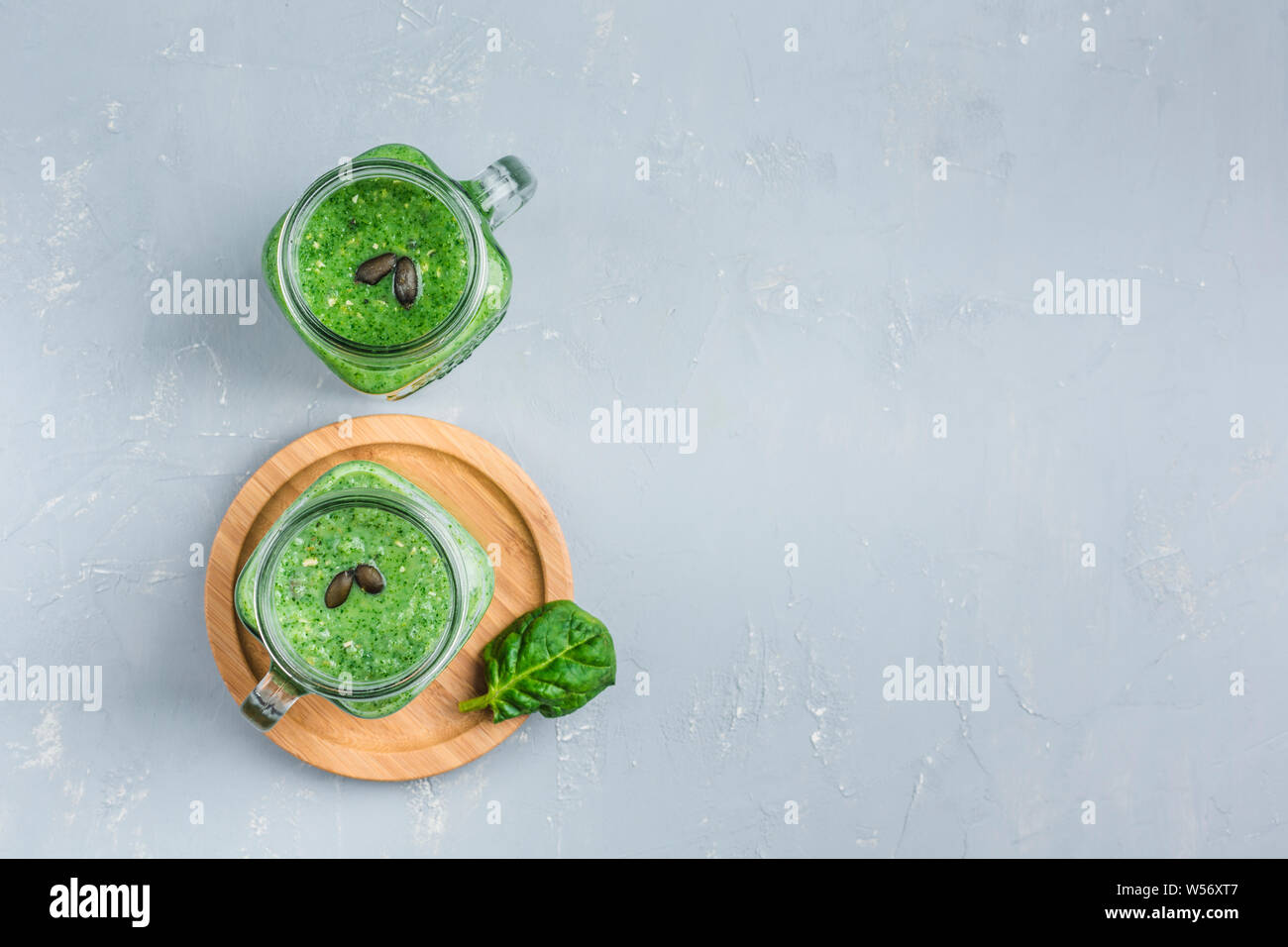 Green smoothie of spinach, Apple, cucumber and coconut milk on a light