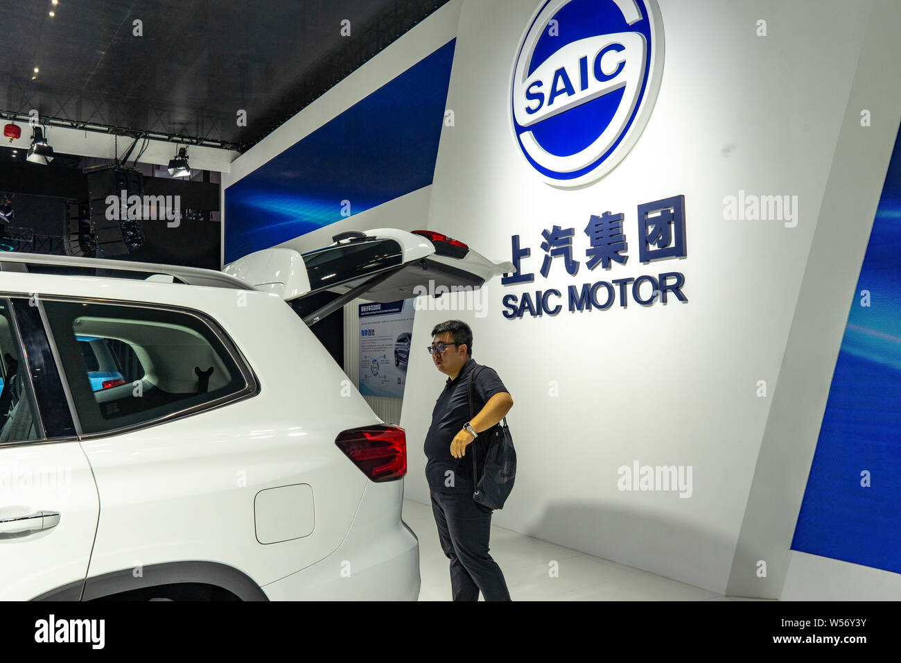 --FILE--A Chinese visitor views a Roewe RX8 hybrid car of SAIC Motor on display during the 20th China International Industry Fair (CIIF 2018) in Shang Stock Photo