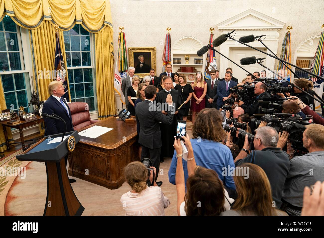 U.S Secretary of Defense Mark Esper, center, takes the oath of office from Supreme Court Associate Justice Samuel Alito as his wife Leah Lacy, center, looks on, during a ceremony in the Oval Office of the White House July 23, 2019 in Washington, DC. Stock Photo