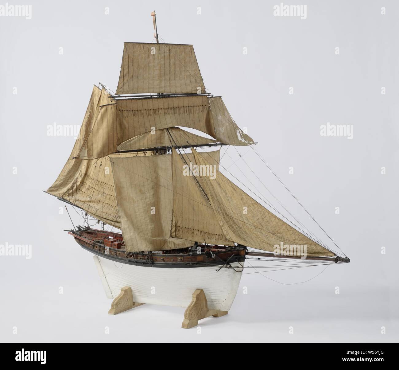 Model of an 18-Gun Cutter, witnessed and polychromed model of an over-built cutter. Thirteen of the eighteen pieces have been preserved. The ship has a slightly curved prow and sharp bow foundation, small flat mirror, large hollow wulf painted with draperies, and a small fence with inscription in winged cartouche, and davits. Falling stern with straight rudder with square rudder king in trousers, wooden tiller in steering wheel bars on deck. The model has an upper and lower deck. On the upper deck a roof, entrance and three hatches. The model is also equipped with a loose galley on the front Stock Photo