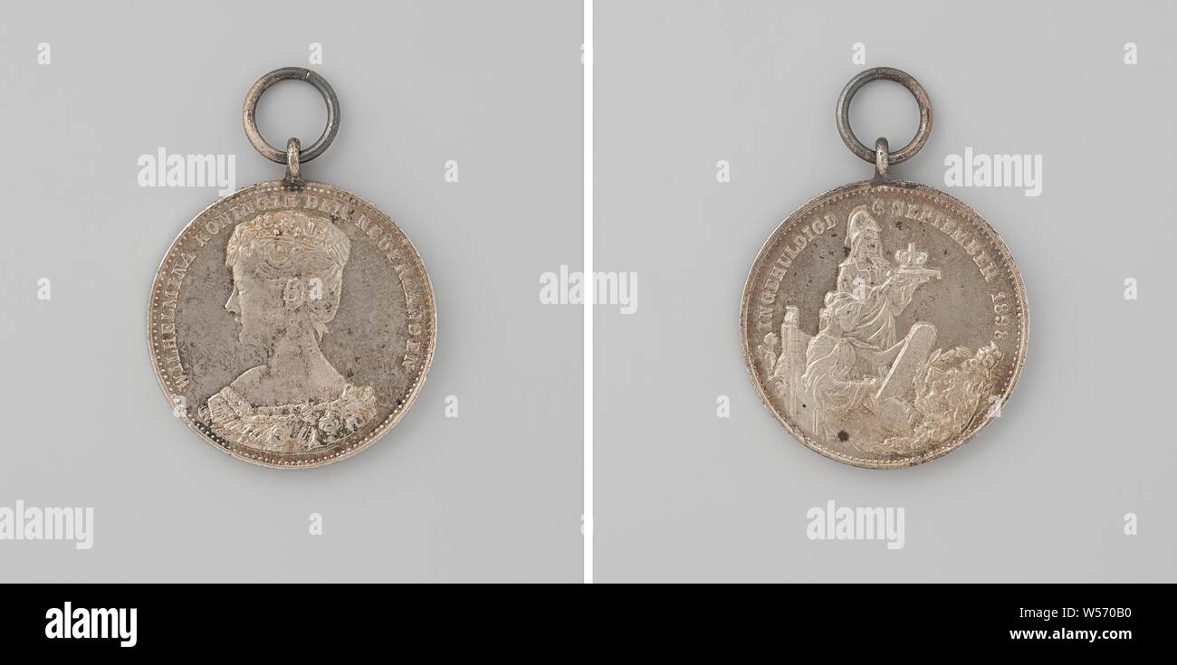 Inauguration of Wilhelmina as queen of the Netherlands, medal awarded to school children, Copper medal to the eyebolt and ring. Obverse: bust of a woman with a diadem inside the inscription. The other side: helmeted woman, representing the Netherlands, holds in her outstretched hands a cushion on which lies a crown, in front of her is History, who writes with pen on the tableau, in the foreground on the right a coat of arms surrounded by laurel branches, with orange ribbon in bottom of matching black box with gold lettering, Amsterdam, Wilhelmina (Queen of the Netherlands), Johannes Albertus Stock Photo