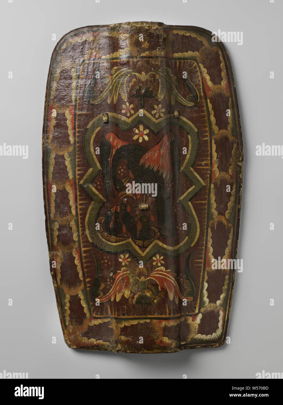 https://c8.alamy.com/comp/W570BD/fifteenth-century-german-shield-painted-with-a-pelican-with-her-boy-elongated-fifteenth-century-german-shield-probably-a-footmans-shield-with-concave-sides-an-increase-of-13-cm-wide-runs-in-the-middle-from-top-to-bottom-completely-covered-with-dark-red-leather-the-front-painted-with-the-representation-of-a-black-pelican-poking-itself-in-the-chest-with-its-beak-above-a-nest-with-four-young-ones-feeding-on-the-falling-drops-of-blood-in-a-four-lobed-frame-surrounded-by-plant-flower-and-abstract-motifs-holes-in-the-shield-at-three-places-through-which-straps-come-off-the-handle-held-W570BD.jpg