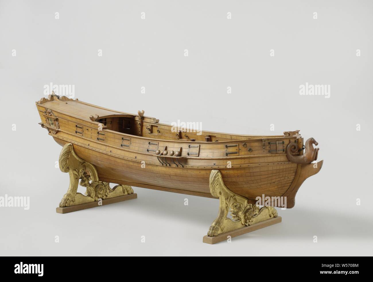 Model of a Yacht, Statenjacht, palm-wood model, equipped for carrying fourteen guns. Without rigging. A sea horse on the prow. The mirror decorated with carved war attributes. The model stands on two sculpted feet, ship model, anonymous, unknown, c. 1400 - c. 1950, wood (plant material), boxwood, h 126 cm × w 38 cm × d 37 cm h 48.5 cm × w 128.5 cm × d 45.5 cm Stock Photo